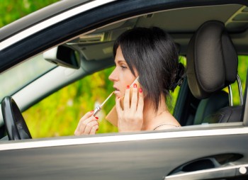 Woman putting on makeup while driving