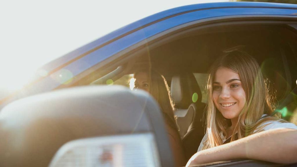 Teen driver behind the wheel of a car needs car insurance for teens.