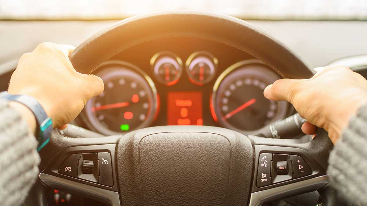 Person in car ready to drive after spending their tax refund on a their car.