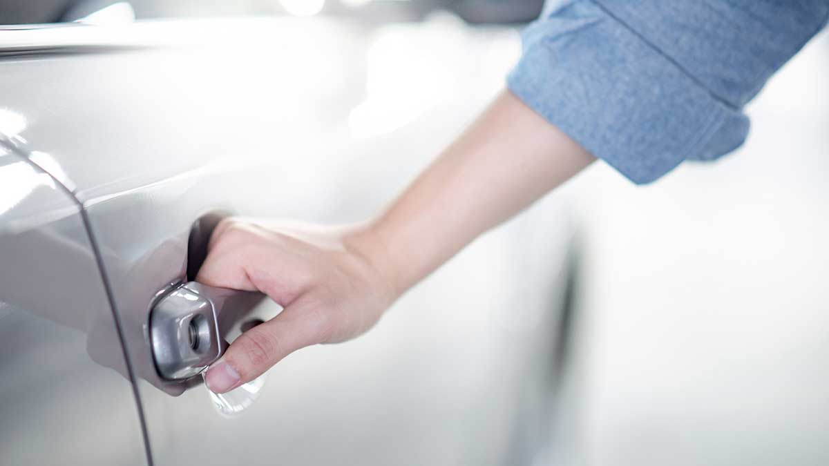 Liability car insurance - woman opening car door