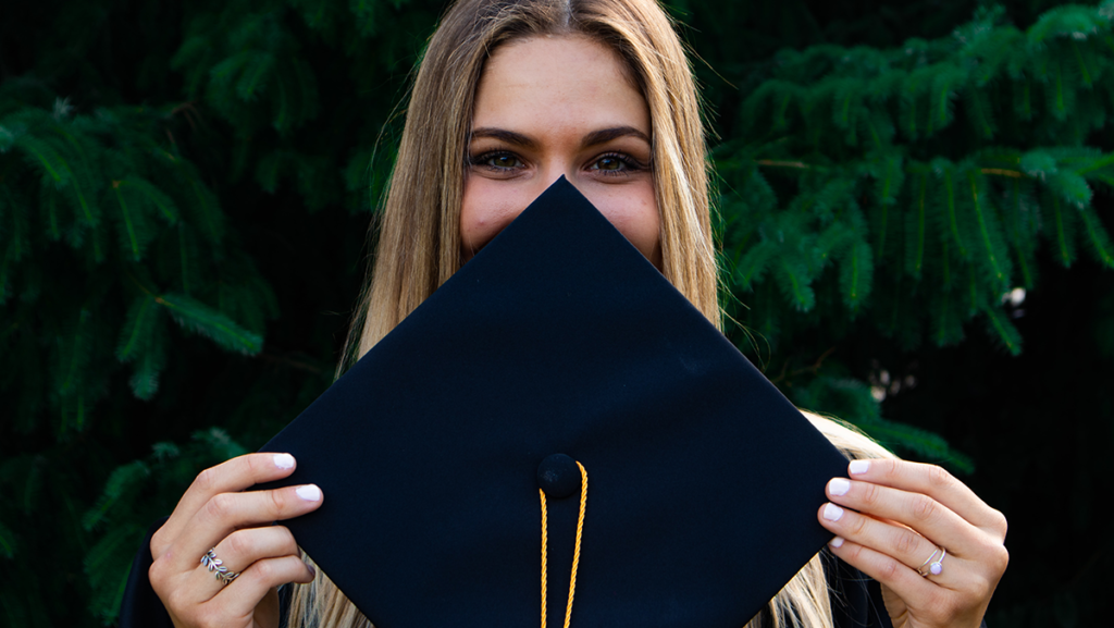 Which college fund is best - female graduate holding cap