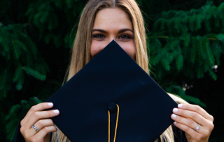 Which college fund is best - female graduate holding cap