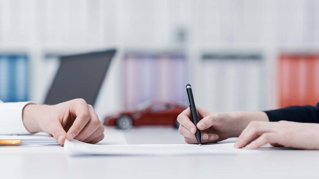 How to Switch Car Insurance - Person signing documents