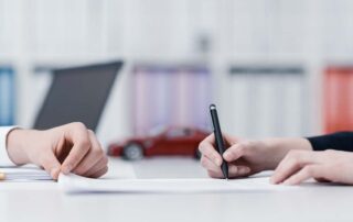 How to Switch Car Insurance - Person signing documents