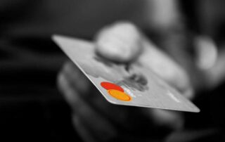 Can you pay for a car with a credit card - person holding out a card
