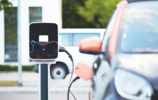 Does the electric vehicle tax credit apply to used cars - car at charging station