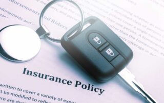 Insurance policy contract and car key - car insurance with a suspended license