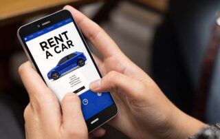 Person renting a car online using their cell phone
