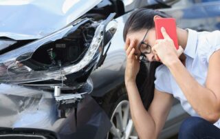 Upset woman on cell phone talking about a car accident without insurance