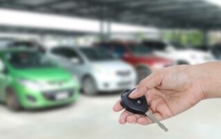 Person looking for car at rental lot - how to get a cheap long term car rental