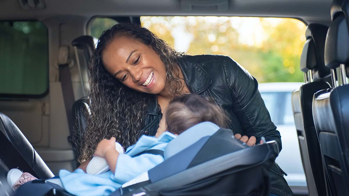 Best family car for car seats - woman with infant in car seat in car