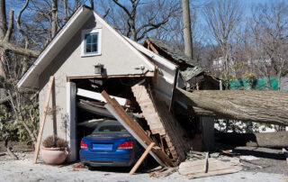 storm damage from tree onto a garage and car