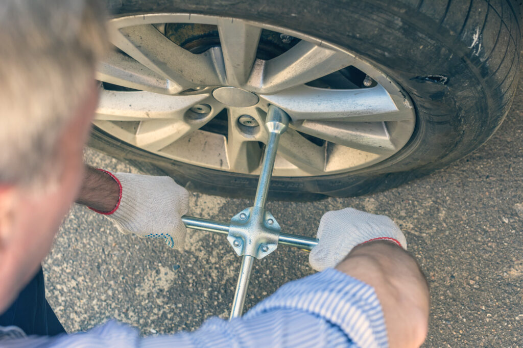 removing lug nuts from a tire / in the process of changing a tire 