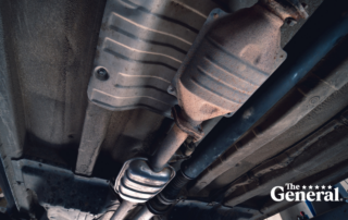 Vehicle underbody exhaust pipe, catalyst, resonator, exhaust system. Old parts require repair and replacement. Car service and maintenance. cardan and outboard bearing