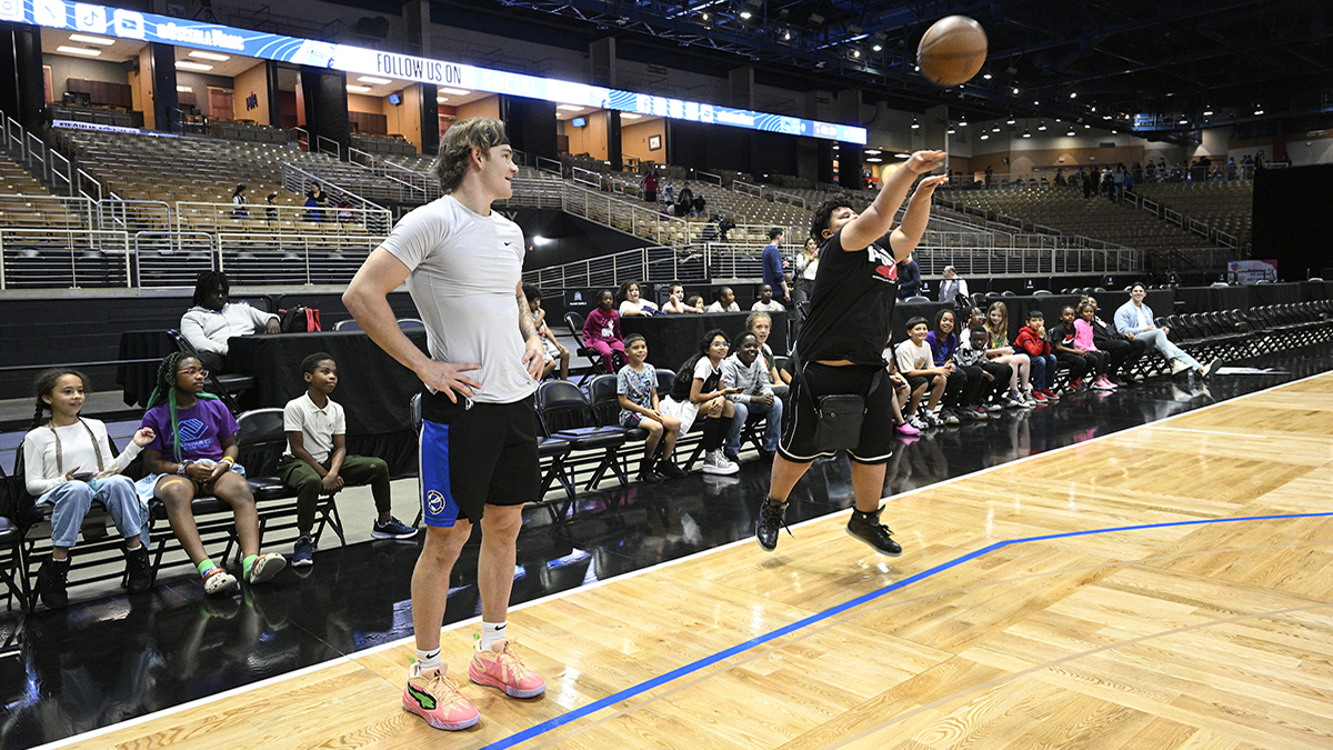 Mac McClung of the Osceola Magic shooting around with youth during Ball for All.
