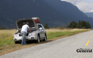 Man inspecting his car, under the hood, trying to figure out why his car won't start. 5 Reasons Why Your Car Won't Start