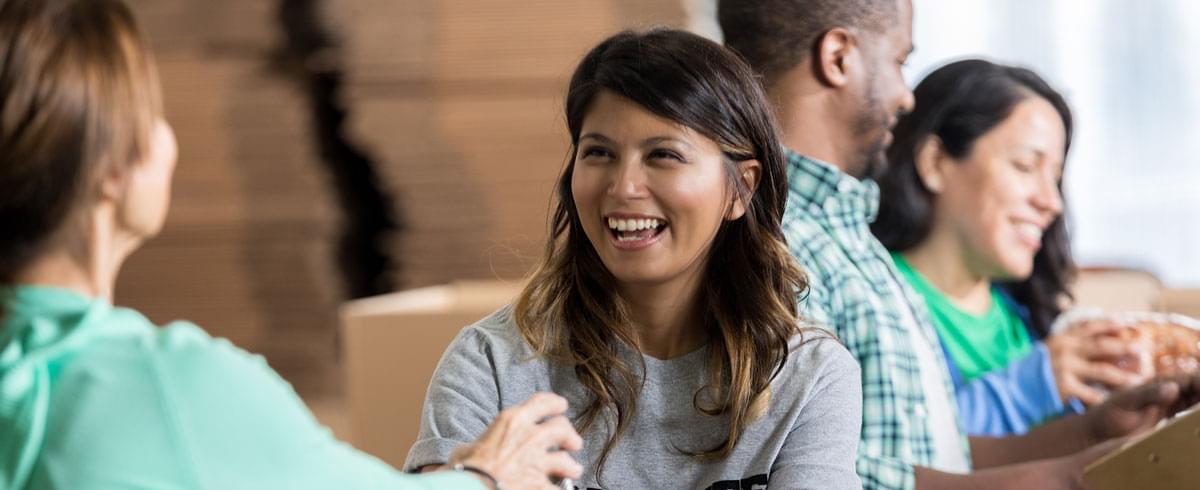 Smiling young women having a conversation.