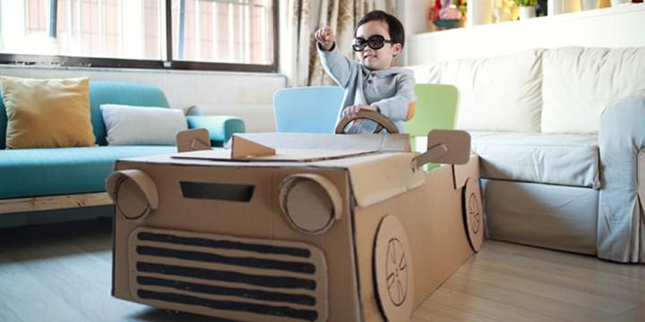Child in a car made from boxes