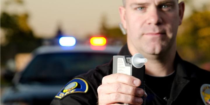Police officer with breathalyzer