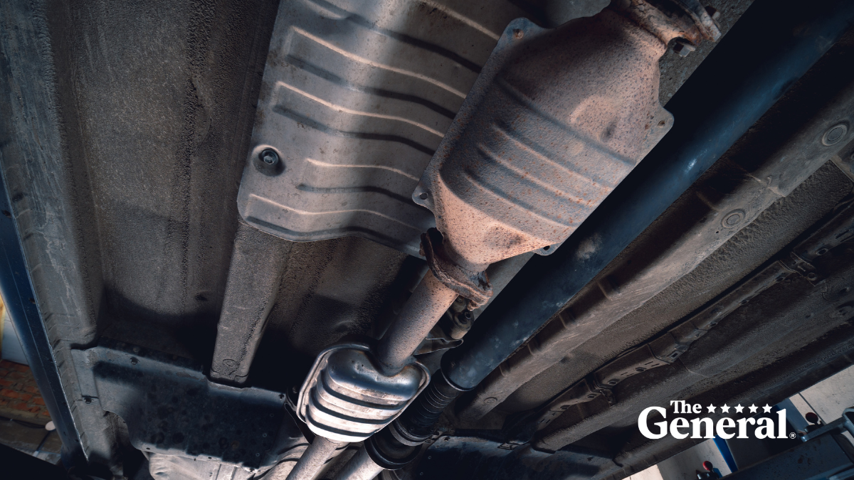 Vehicle underbody exhaust pipe, catalyst, resonator, exhaust system. Old parts require repair and replacement. Car service and maintenance. cardan and outboard bearing